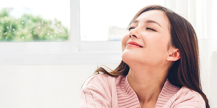 woman breathing in fresh air