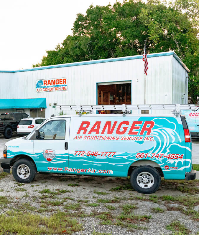 company van in front of warehouse